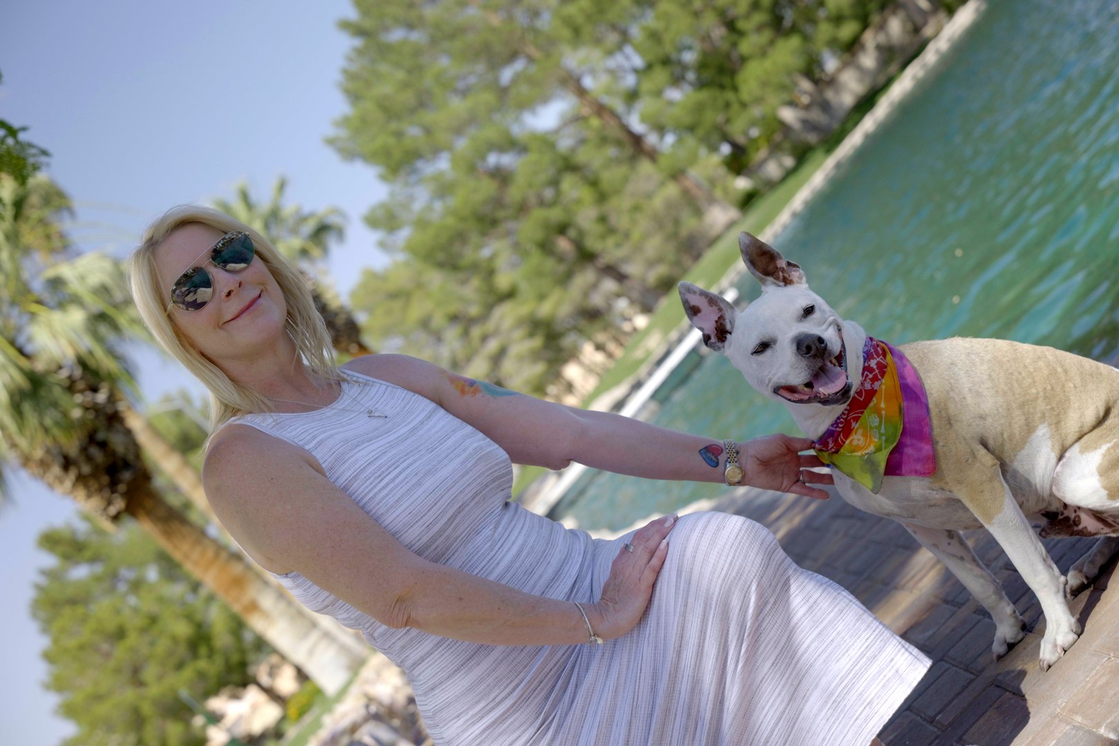 Tricia Davis smiling with Panic beside the water